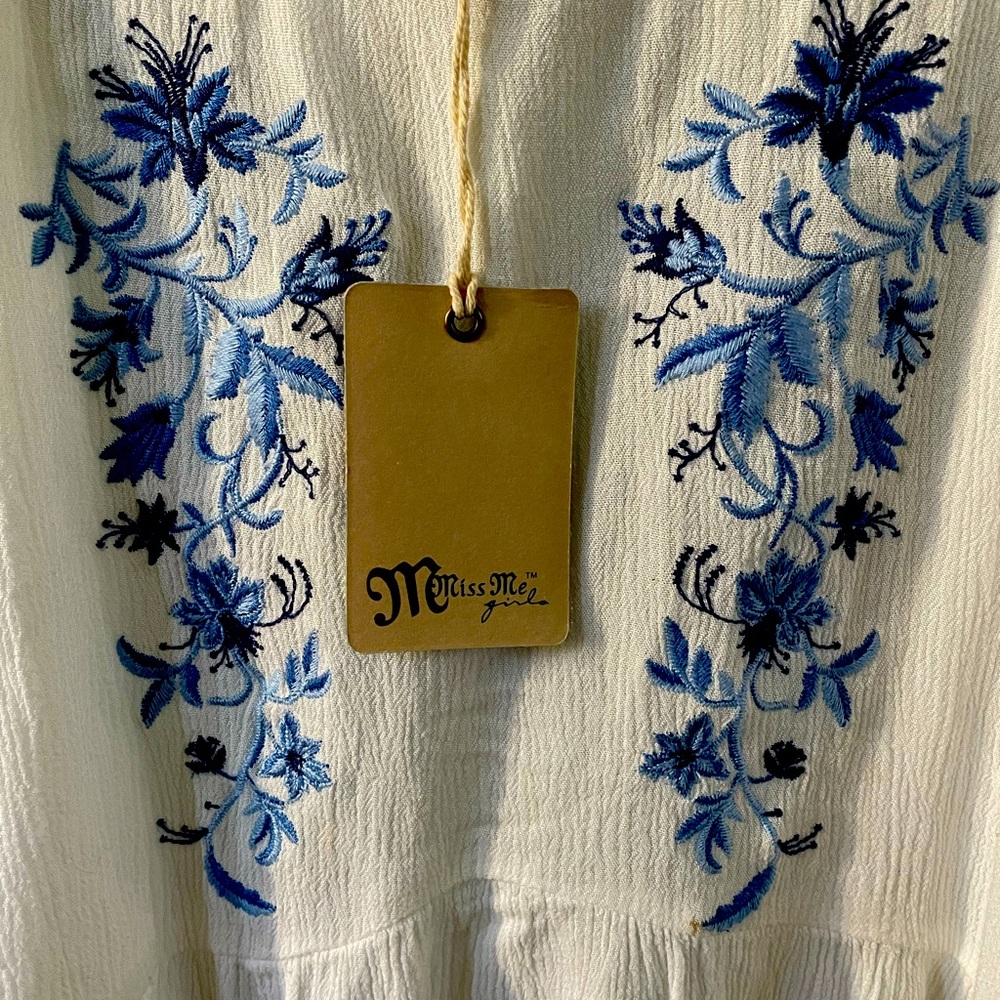 Lightweight top with an embroidered design featuring intricate floral patterns.